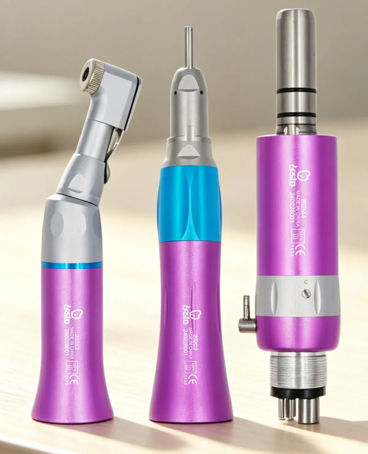 Purple low-speed contra-angle, straight handpiece and air motor 202M4 on a table